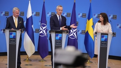 Finland's Foreign Minister Pekka Haavisto, left, Sweden's Foreign Minister Ann Linde, right, and NATO Secretary General Jens Stoltenberg attend a media conference after the signature of the NATO Accession Protocols for Finland and Sweden in the NATO headquarters in Brussels. (AP)
