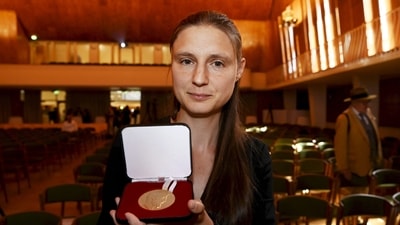 Ukraine's Maryna Viazovska presents her medal after receiving the 2022 Fields Prize for Mathematics during the International Congress of Mathematicians 2022 (ICM 2022) in Helsinki, Finland. (AFP) Ukraine's Maryna Viazovska presents her medal after receiving the 2022 Fields Prize for Mathematics during the International Congress of Mathematicians 2022 (ICM 2022) in Helsinki, Finland. (AFP)