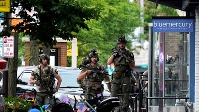 Law enforcement search after a mass shooting at the Highland Park Fourth of July parade in downtown Highland Park, Ill., Monday, July 4, 2022. A gunman on a rooftop opened fire on an Independence Day parade in suburban Chicago on Monday. (AP Photo/Nam Y. Huh) (AP) Law enforcement search after a mass shooting at the Highland Park Fourth of July parade in downtown Highland Park, Ill., Monday, July 4, 2022. A gunman on a rooftop opened fire on an Independence Day parade in suburban Chicago on Monday. (AP Photo/Nam Y. Huh) (AP)