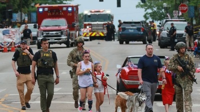 More than 100 law enforcement officers were called to the parade scene or dispatched to find the suspected shooter. (AFP)