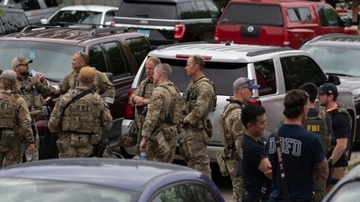 Officers gather at the scene of the Fourth of July parade shooting in Highland Park, Illinois. (AFP) Officers gather at the scene of the Fourth of July parade shooting in Highland Park, Illinois. (AFP)
