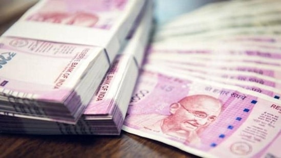 Indian Rupee money stacks and banknotes on the table , closed up shot (Shutterstock)