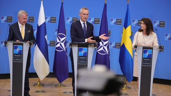 Finland's Foreign Minister Pekka Haavisto, left, Sweden's Foreign Minister Ann Linde, right, and NATO Secretary General Jens Stoltenberg attend a media conference after the signature of the NATO Accession Protocols for Finland and Sweden in the NATO headquarters in Brussels.(AP)