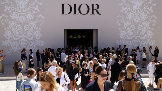 People stand outside the venue after the Dior Haute Couture Fall/Winter 2022-2023 collection show in Paris.&nbsp;(REUTERS)