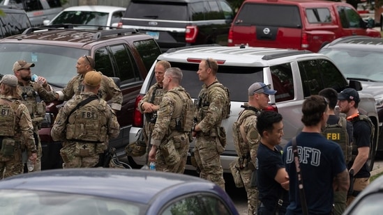 Officers gather at the scene of the Fourth of July parade shooting in Highland Park, Illinois.&nbsp;(AFP)