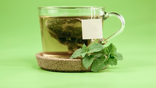 Drink green tea instead of caffeinated drinks: Avoid drinking caffeinated tea or coffee and swap it with a cup of green tea. It helps boost metabolism and keeps the digestive system clean.(Unsplash)