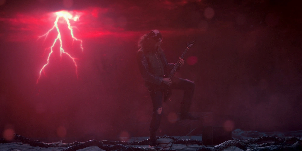 Joseph Quinn playing the guitar in a scene from Stranger Things season 4 finale (Image courtesy Netflix).