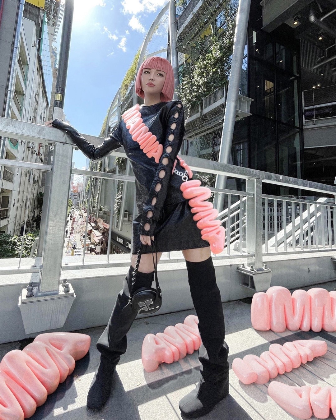 Japan’s Imma dons a cutout futuristic black dress with thigh-high boots and matching sling bag (Instagram) Japan’s Imma dons a cutout futuristic black dress with thigh-high boots and matching sling bag (Instagram)