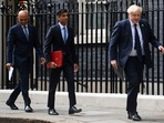 From left, British Health Secretary Sajid Javid, Chancellor of the Exchequer Rishi Sunak and Prime Minister Boris Johnson arrive at No 9 Downing Street for a media briefing on May 7, 2021. (AP) From left, British Health Secretary Sajid Javid, Chancellor of the Exchequer Rishi Sunak and Prime Minister Boris Johnson arrive at No 9 Downing Street for a media briefing on May 7, 2021. (AP)