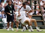 Novak Djokovic helps Jannik Sinner during their match at Wimbledon Novak Djokovic helps Jannik Sinner during their match at Wimbledon