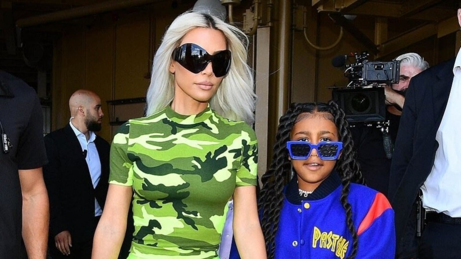 kim kardashian looks striking in a camo top and neon green