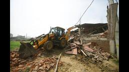 Demolition drive at Nepali Nagar on Sunday. (Santosh Kumar/HT Photo)