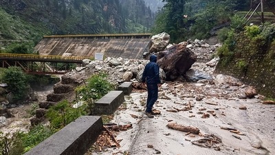 A man stands near a blocked road following a landslide due to heavy rainfall, near Malana in Kullu district. (PTI) A man stands near a blocked road following a landslide due to heavy rainfall, near Malana in Kullu district. (PTI)