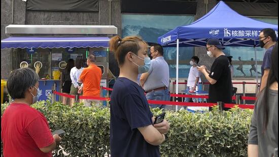 Residents line up for Covid-19 testing in Shanghai, on Wednesday. Residents of parts of Shanghai and Beijing have been ordered to undergo further rounds of testing following the discovery of new cases in the two cities. (AP)