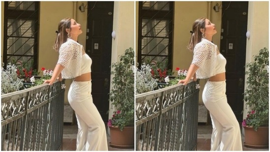 Hina decked up in a white cropped top and teamed it with a pair of white trousers with wide legs.(Instagram/@realhinakhan)