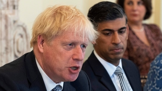 Britain's Prime Minister Boris Johnson, foreground and Britain's Chancellor of the Exchequer Rishi Sunak take part in a cabinet meeting.(AP)