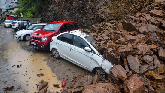 Vehicles buried under debris after landslides triggered by heavy rains in Shimla.(PTI)