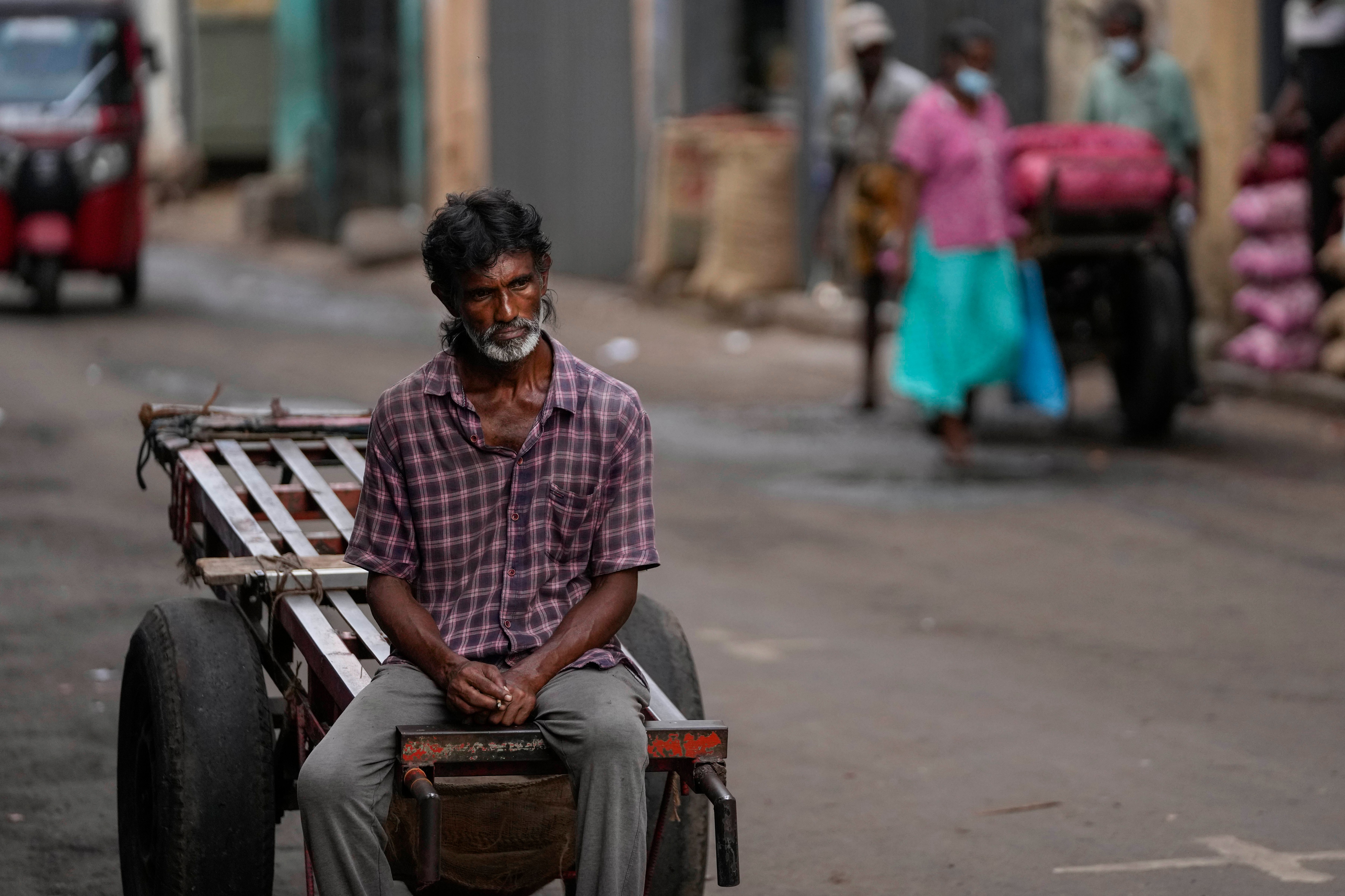 A daily wage laborer waits for work at a wholesale market in Colombo, Sri Lanka, Sunday on June 26, 2022. (AP)