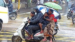 A family on a motorbike during the rains.