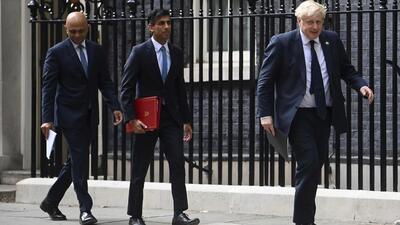 (Left to right) Former British health secretary Sajid Javid, ex-chancellor of the exchequer Rishi Sunak and acting Prime Minister Boris Johnson arrive at No 9 Downing Street for a media briefing on May 7, 2021. The contest to succeed British Prime Minister Boris Johnson has no single frontrunner but there are many prominent contenders. (AP)