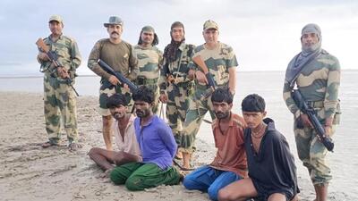 Border Security Force personnel with the apprehended Pakistan nationals in Kutch, Gujarat. (BSF Photo) Border Security Force personnel with the apprehended Pakistan nationals in Kutch, Gujarat. (BSF Photo)