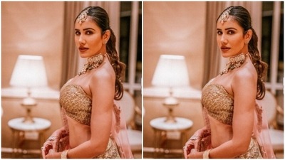 Sonnalli paired a golden embellished blouse that came with one sleeveless shoulder with a long flowy ivory white skirt with intricate decorations in golden sequins. She added a blush pink dupatta with golden zari details and completed her look. (Instagram/@sonnalliseygall)