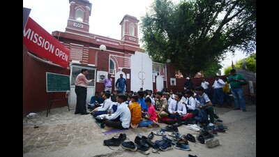 students of government-aided Centennial Inter College in Lucknow attending their class outside the school on Thursday. (Deepak Gupta/HT photo)