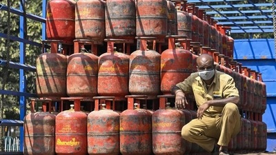 A worker sits inside a lorry, stacked with LPG cylinders . (PT Phto) A worker sits inside a lorry, stacked with LPG cylinders . (PT Phto)
