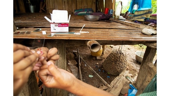 A doctor draws blood from a Toto tribal to test for malaria. Totopara has only one Primary Health Centre. In cases of emergency or serious illness, patients are generally sent to the general government hospital in Birpara, about 35 km away.(Abhijit AA / Totos of Totopara)