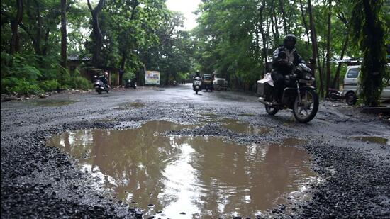 Motorists navigate through potholes which resurfaced near Marol Naka at Goregaon (Vijay Bate)