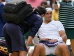 Spain's Rafael Nadal receives treatment just before a medical timeout as he plays Taylor Fritz of the US in a men's singles quarterfinal Spain's Rafael Nadal receives treatment just before a medical timeout as he plays Taylor Fritz of the US in a men's singles quarterfinal