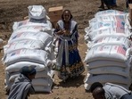 FILE - An Ethiopian woman stands by sacks of wheat to be distributed by the Relief Society of Tigray in the town of Agula, in the Tigray region of northern Ethiopia Saturday. (AP) FILE - An Ethiopian woman stands by sacks of wheat to be distributed by the Relief Society of Tigray in the town of Agula, in the Tigray region of northern Ethiopia Saturday. (AP)