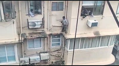 A video grab of the incident shows residents persuading him to enter one of the houses on the fourth floor. HT Photo
