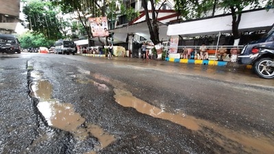 Potholes outside CM Eknath Shinde’s residence in Thane. The PWD has claimed that there are only 37 potholes on the 18km stretch on Ghodbunder Road. (PRAFUL GANGURDE/HT PHOTO) Potholes outside CM Eknath Shinde’s residence in Thane. The PWD has claimed that there are only 37 potholes on the 18km stretch on Ghodbunder Road. (PRAFUL GANGURDE/HT PHOTO)