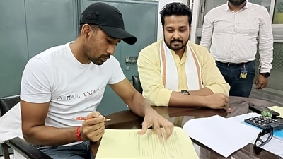 Saha signs the documents as he will join the Tripura cricket team as a player-cum-mentor during a press meet, in Agartala on Friday. (Sushanta Das)