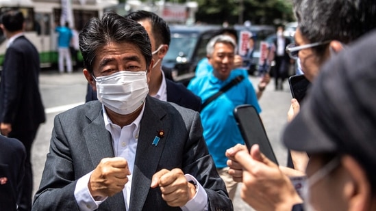 Former Japanese prime minister Shinzo Abe interacts with supporters during the election campaign for Liberal Democratic Party member Kentaro Asah.(AFP)