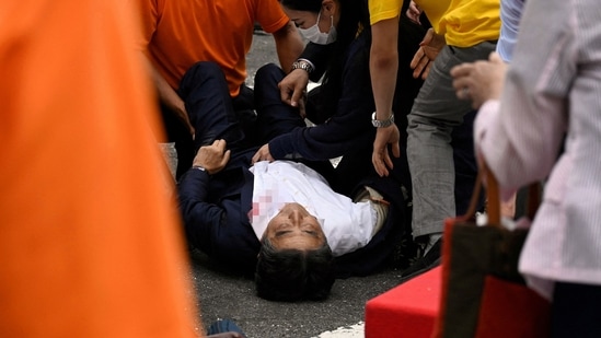 Former Japanese Prime Minister Shinzo Abe lies on the ground after he was shot during an election campaign in Nara, western Japan on Friday. He later lost his life after succumbing to his injuries. (The Asahi Shimbun/via REUTERS)