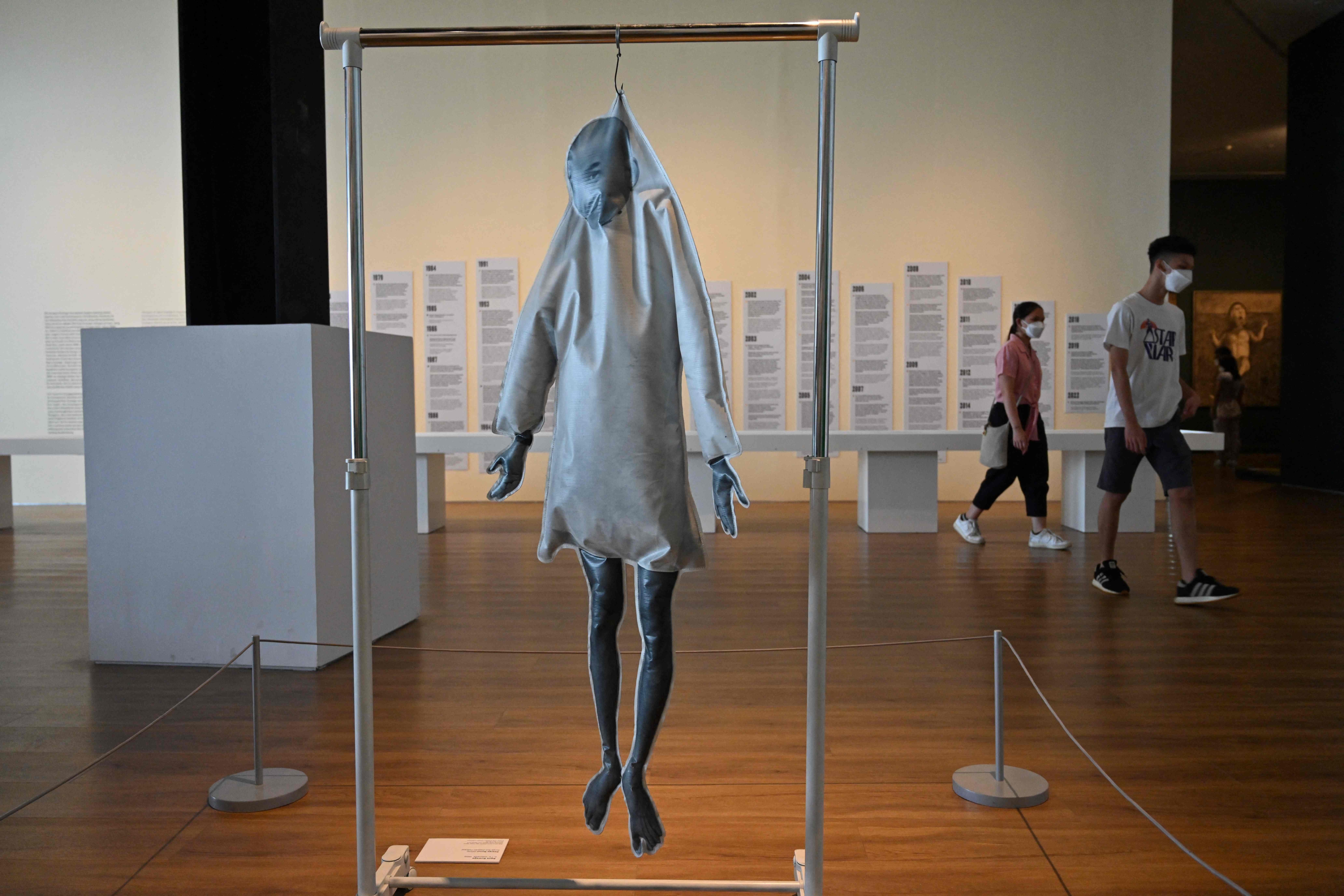 This picture taken on June 30, 2022 shows people walking past the artwork entitled �Heaven Follow� at an exhibition by Indonesian artist Agus Suwage called 'The Theatre of Me' at the Macan Museum of Modern and Contemporary Art in Jakarta. - For 30 years Indonesian artist Agus Suwage has been revealing himself in self-portraits . (AFP) This picture taken on June 30, 2022 shows people walking past the artwork entitled �Heaven Follow� at an exhibition by Indonesian artist Agus Suwage called 'The Theatre of Me' at the Macan Museum of Modern and Contemporary Art in Jakarta. - For 30 years Indonesian artist Agus Suwage has been revealing himself in self-portraits . (AFP)