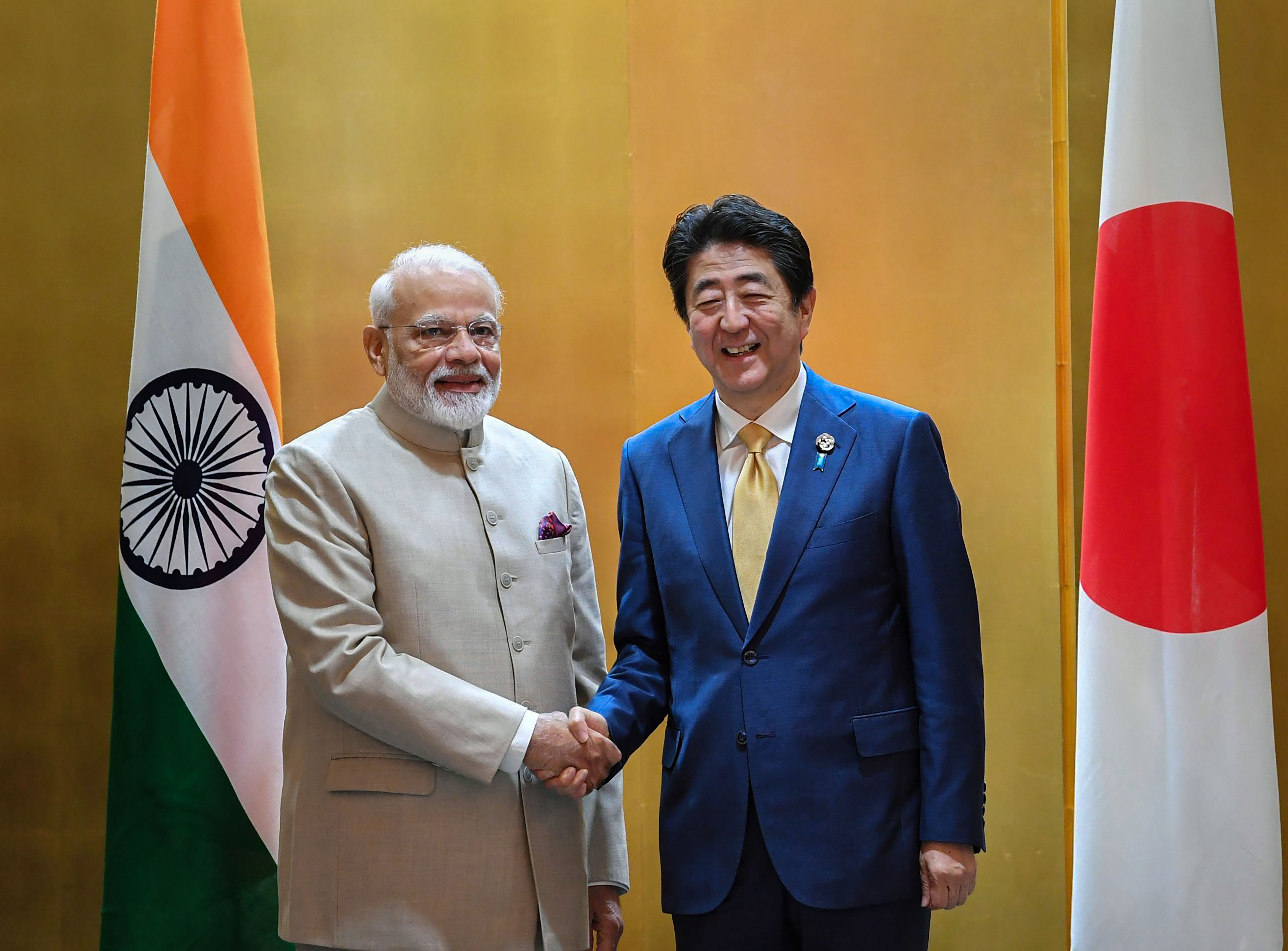 In this June 27, 2019 file photo Prime Minister Narendra Modi shakes hands with his Japanese counterpart Shinzo Abe prior to their meeting in Osaka, Japan. (PTI file photo) In this June 27, 2019 file photo Prime Minister Narendra Modi shakes hands with his Japanese counterpart Shinzo Abe prior to their meeting in Osaka, Japan. (PTI file photo)