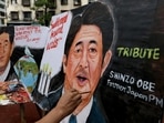 An artist applies finishing touches to a painting of late Japan's former Prime Minister Shinzo Abe.