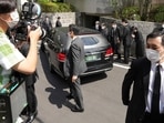 A car which is believed to carry the body of former Prime Minister Shinzo Abe, arrives at his home.