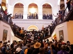 Demonstrators protest inside the President's House, after President Gotabaya Rajapaksa fled, amid the country's economic crisis, in Colombo,