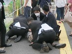 Four armed police officers pin down Tetsuya Yamagami after he shot former Japan Prime Minister Shinzo Abe in Nara on Friday.