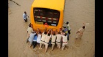 Police personnel push a school bus stuck on a waterlogged road at Subhash chowk in Gurugram. (HT archive) Police personnel push a school bus stuck on a waterlogged road at Subhash chowk in Gurugram. (HT archive)