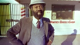 Oprah Winfrey's father, Vernon Winfrey, stands outside a barbershop in Nashville, Tennessee, in 1987.