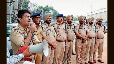 Cops during the raids in Kingra Chowala village in Jalandhar on Saturday. (HT Photo)