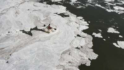 A man rides a makeshift boat through toxic foam floating in Yamuna river in New Delhi. (PTI File Image) A man rides a makeshift boat through toxic foam floating in Yamuna river in New Delhi. (PTI File Image)