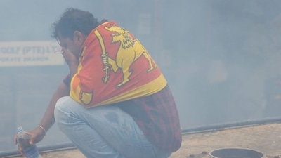 A demonstrator reacts to tear gas used by police during a protest demanding the resignation of President Gotabaya Rajapaksa, amid the country's economic crisis, near the president's residence in Colombo. (Reuters)