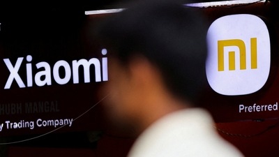 A man walks past a logo of Xiaomi, a Chinese manufacturer of consumer electronics, outside a shop in Mumbai.&nbsp; (REUTERS)