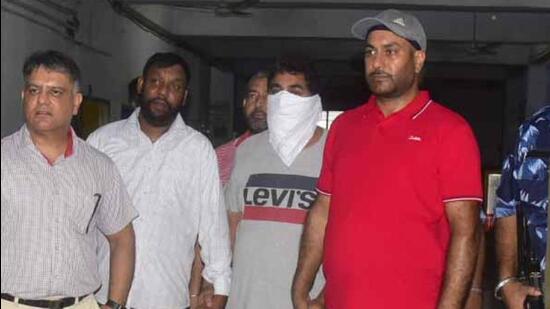 Sandeep Singh alias Sona (face covered) being produced in the court after his arrest in the Sidhu Moose Wala murder case, in Ludhiana on Saturday. (Gurpreet Singh/HT) Sandeep Singh alias Sona (face covered) being produced in the court after his arrest in the Sidhu Moose Wala murder case, in Ludhiana on Saturday. (Gurpreet Singh/HT)